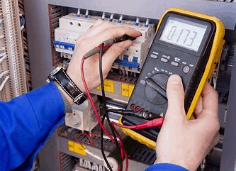 electrician testing electrical panel for electrical safety checks