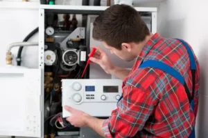 Plumber repairing a water heater, checking components and settings, emphasizing emergency plumbing services in Pinal County