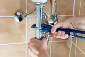 local plumber repairing a bathroom plumbing in Pinal County home