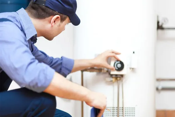 a plumber undertaking a plumbing maintenance on a water heater